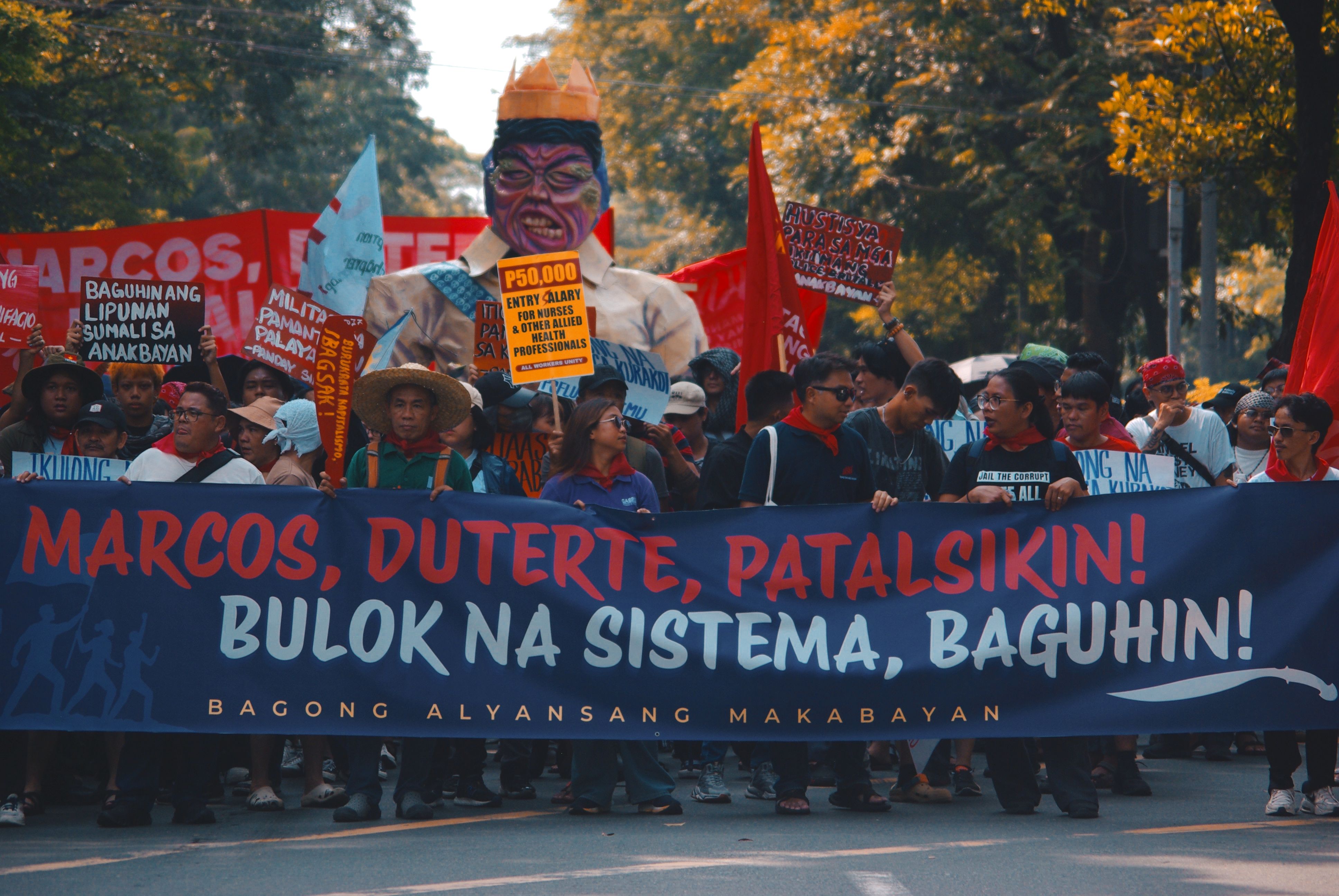 Street protest with demonstrators holding political banners demanding change