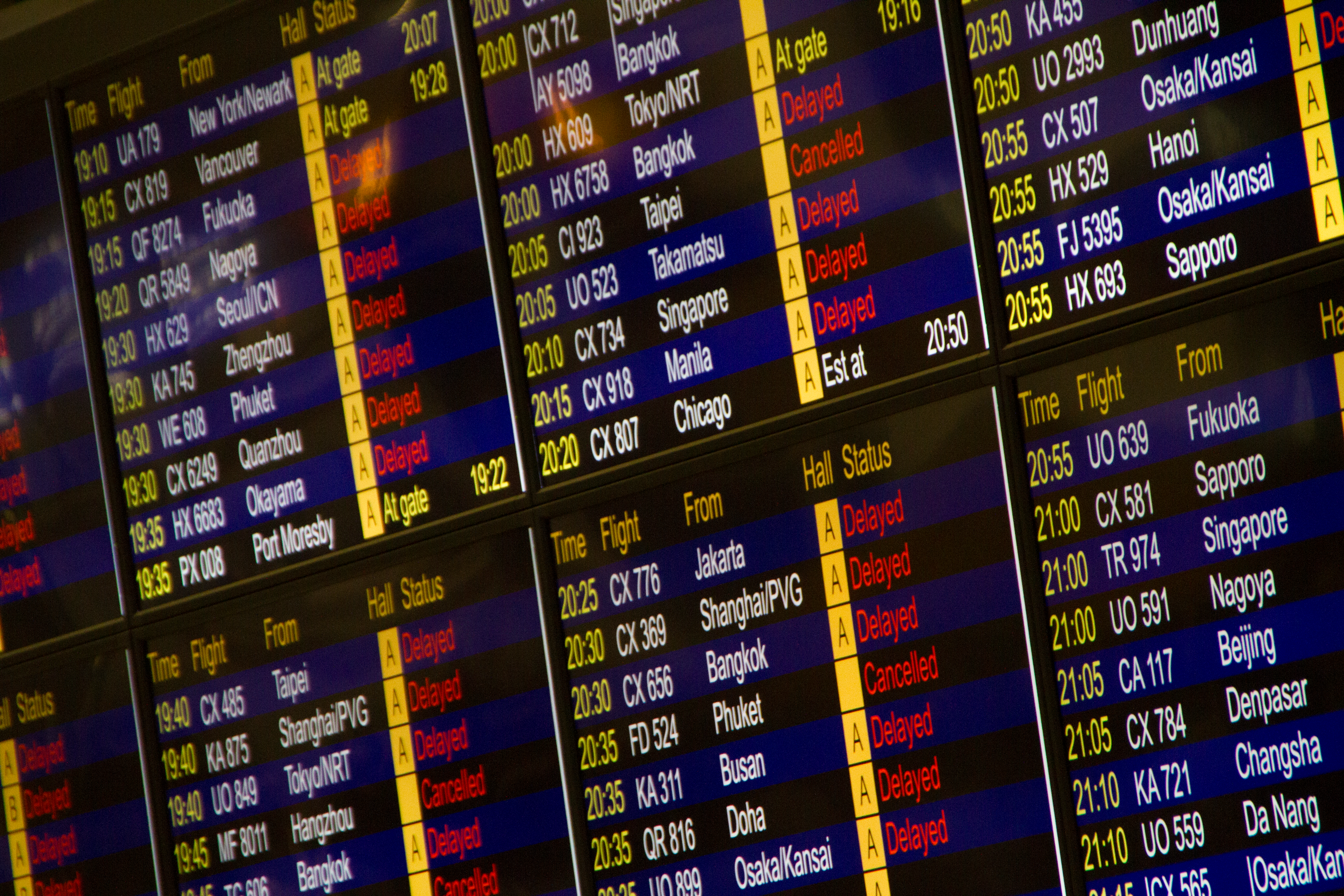 Digital airport flight information board showing arrivals and departures